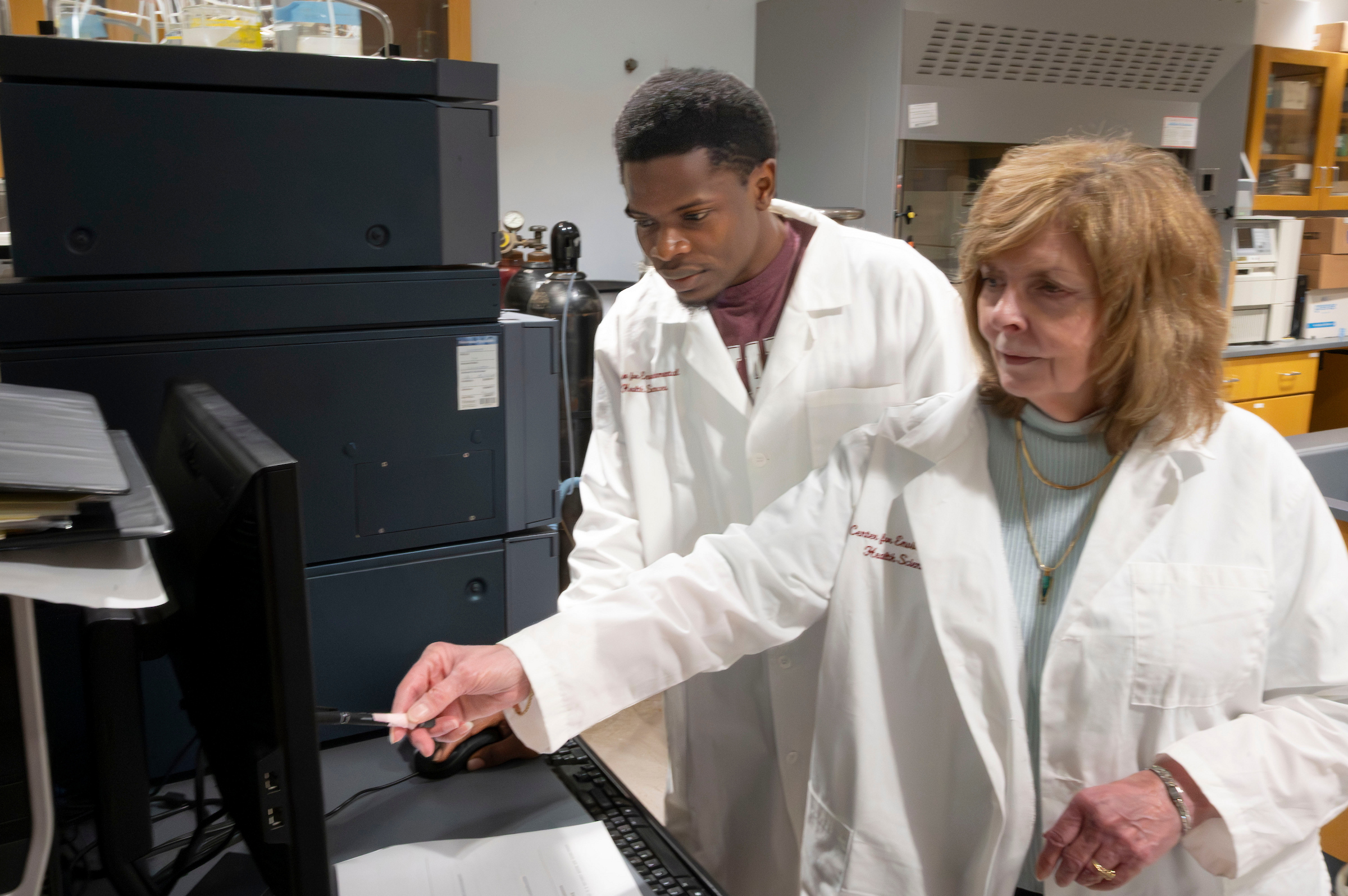 Dr. Jan Chambers and a student look at some equipment.