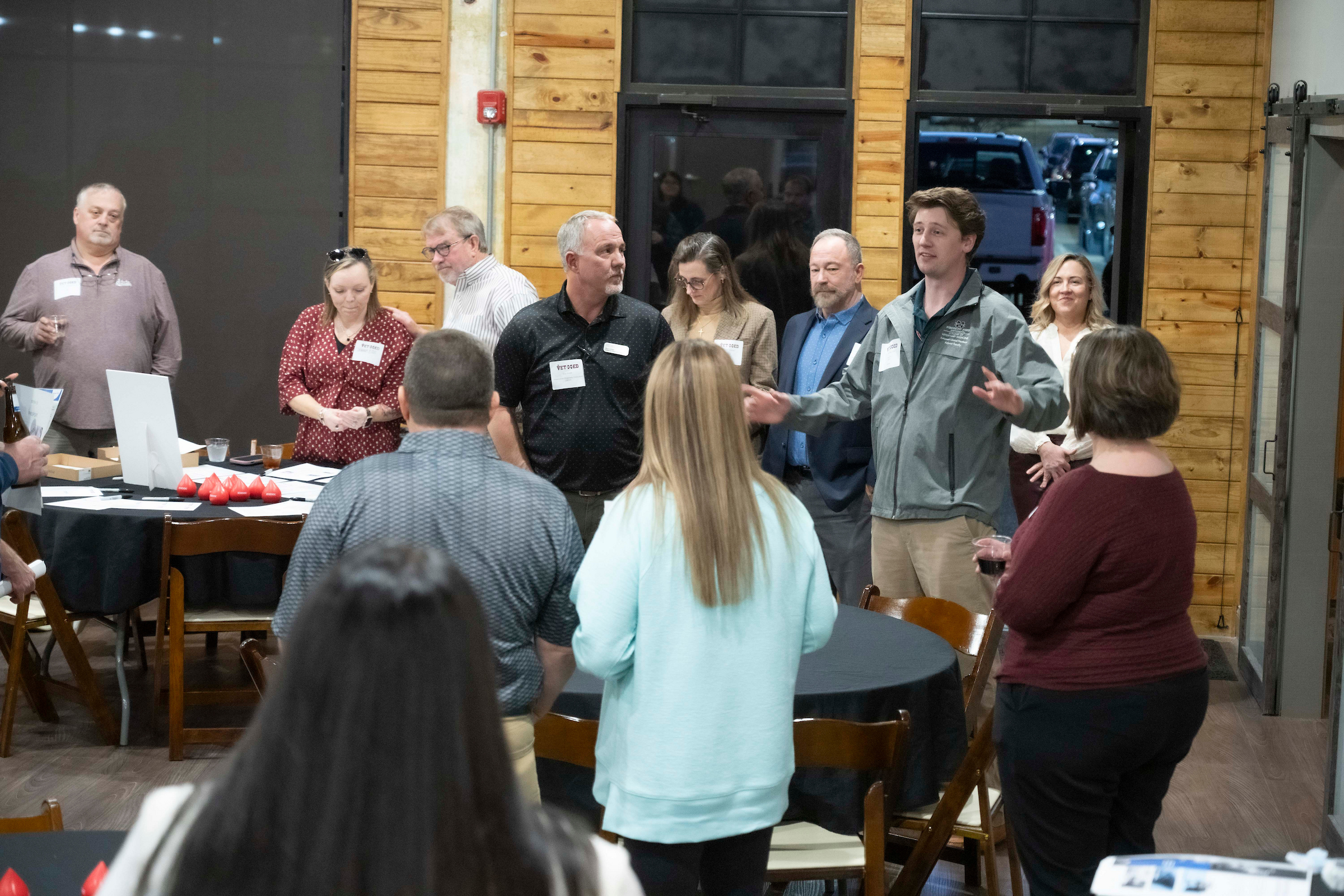 Twelve people listen to Dr. Yates speak.