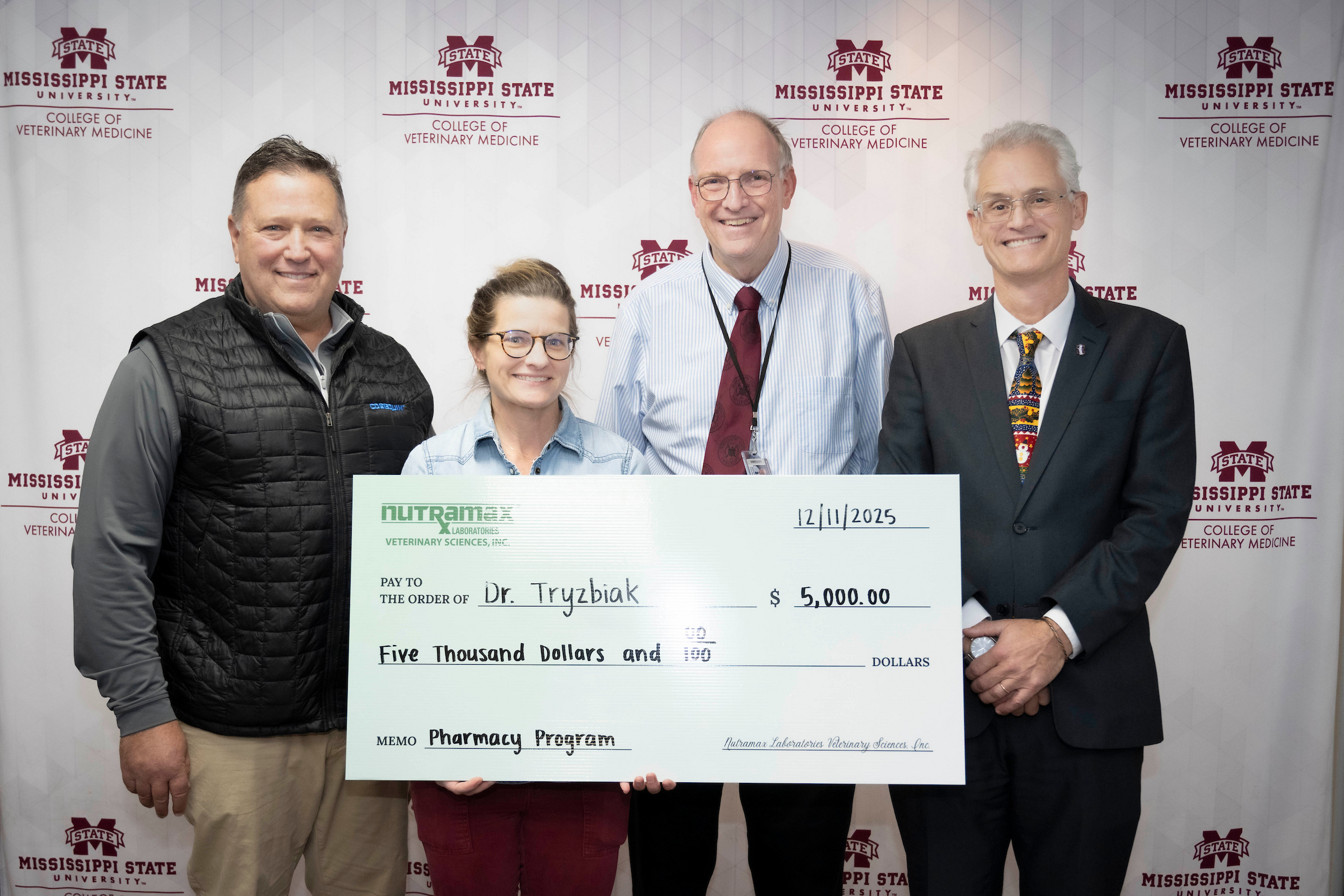 Four people and a big check