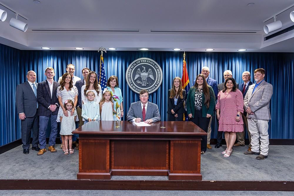 Governor Tate Reeves and others at the signing of the Dr. Mac Huddleston scholarship in 2024