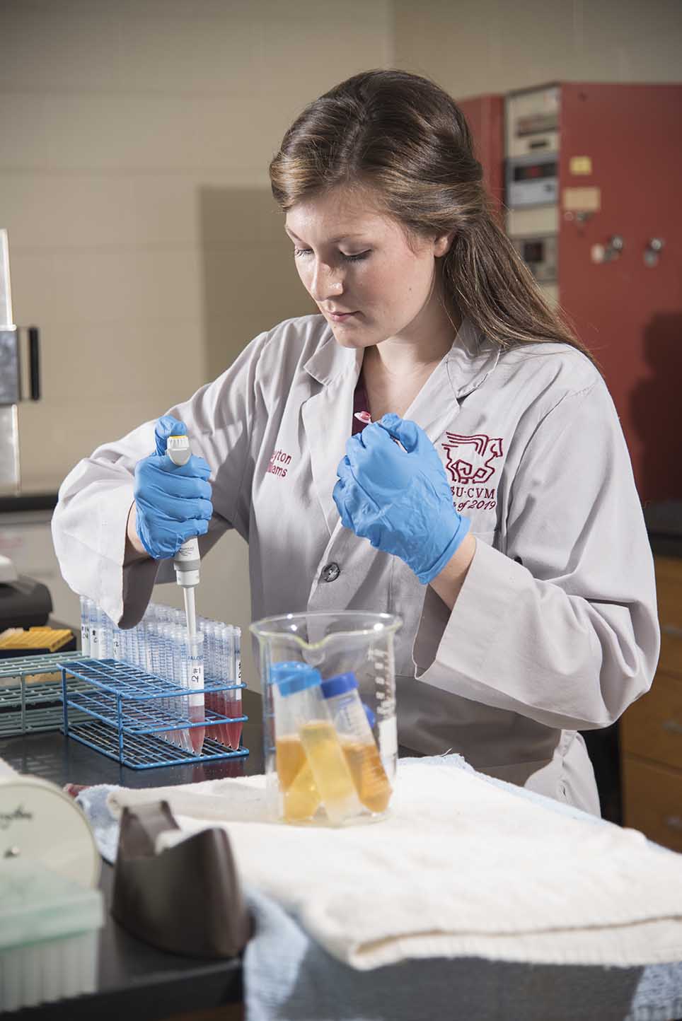 Student filling vial samples in a lab
