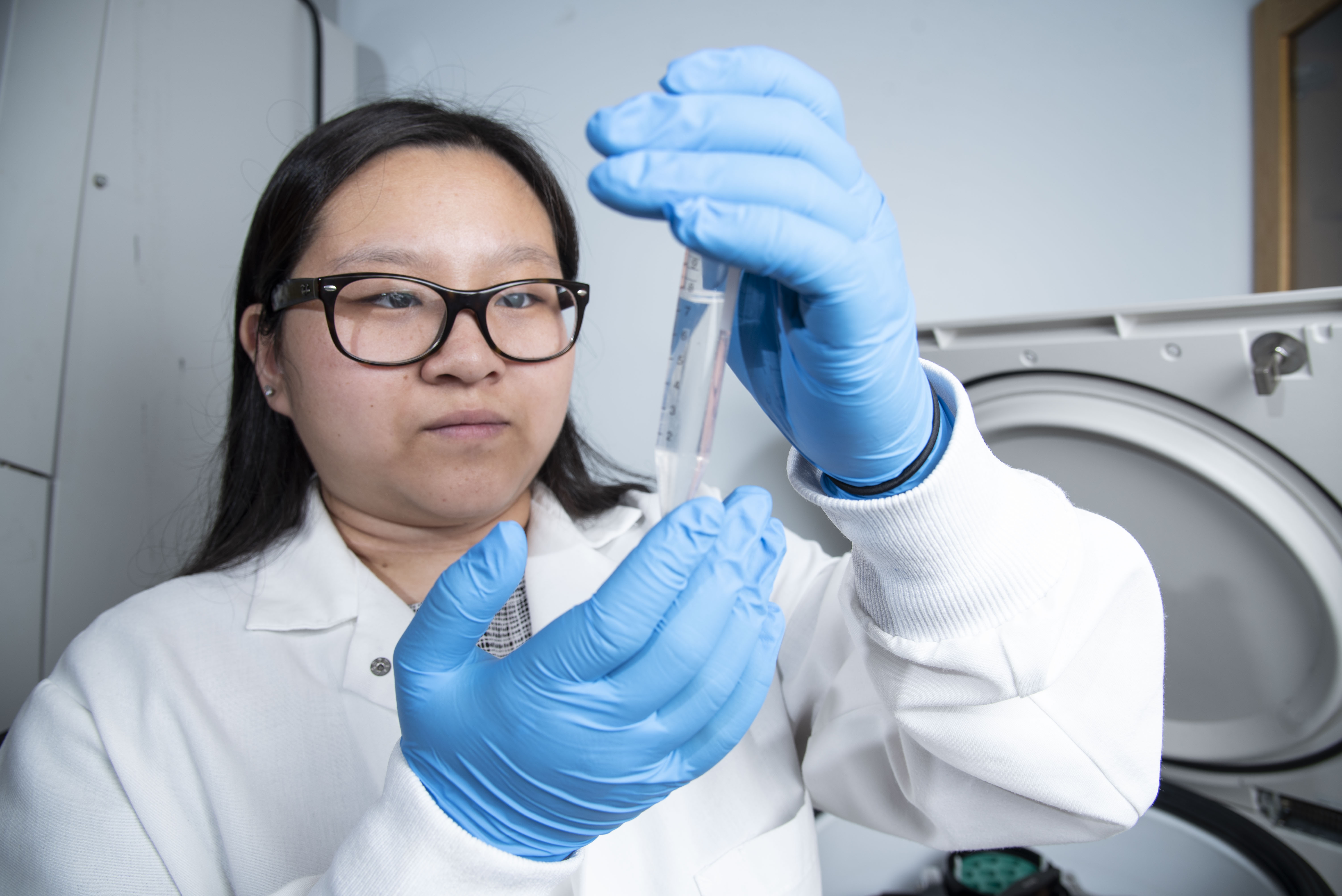 Student in a research lab, analyzing sample