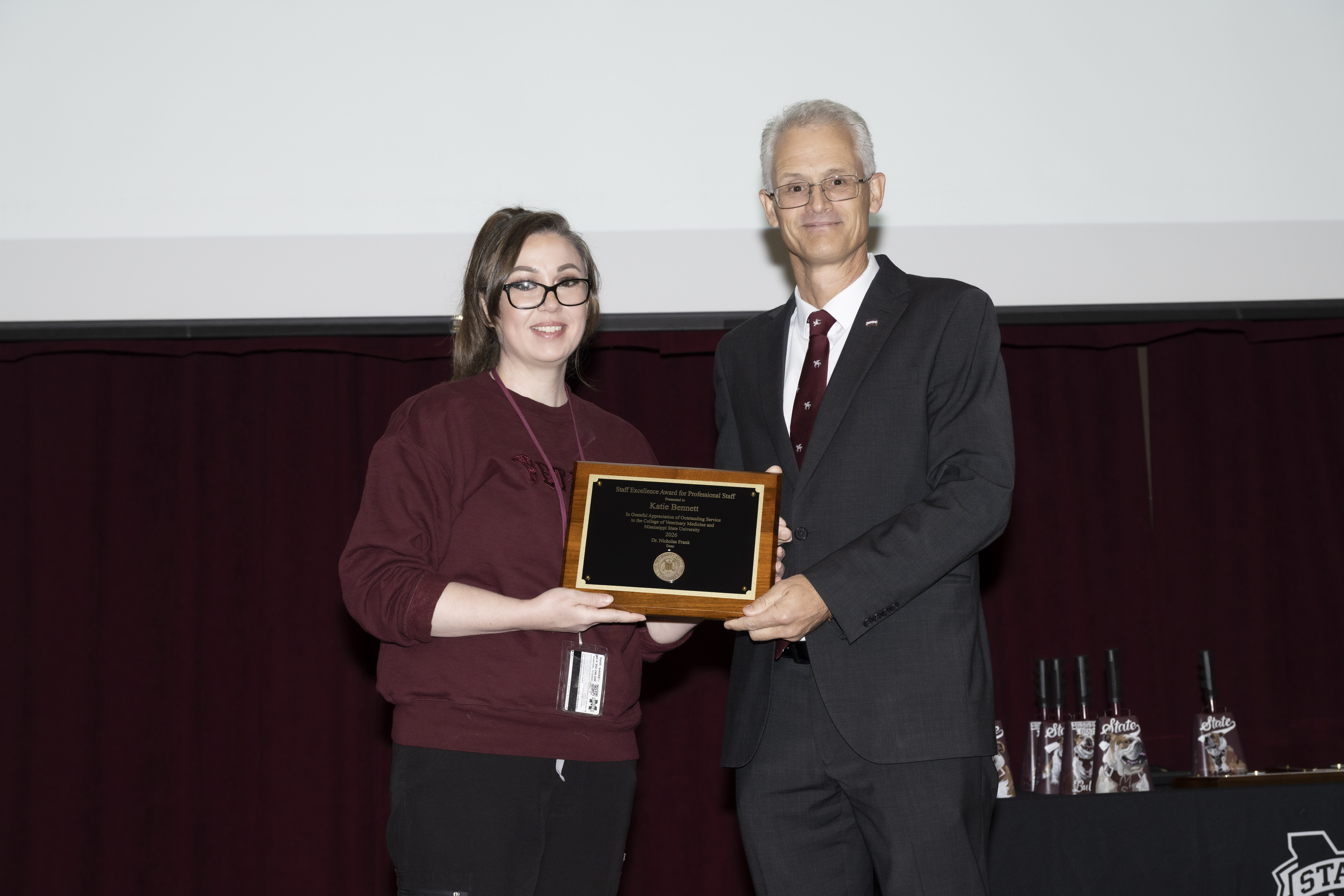 Katie Bennett receives the Staff Excellence Award for Professional Staff from Dean Nicholas Frank.