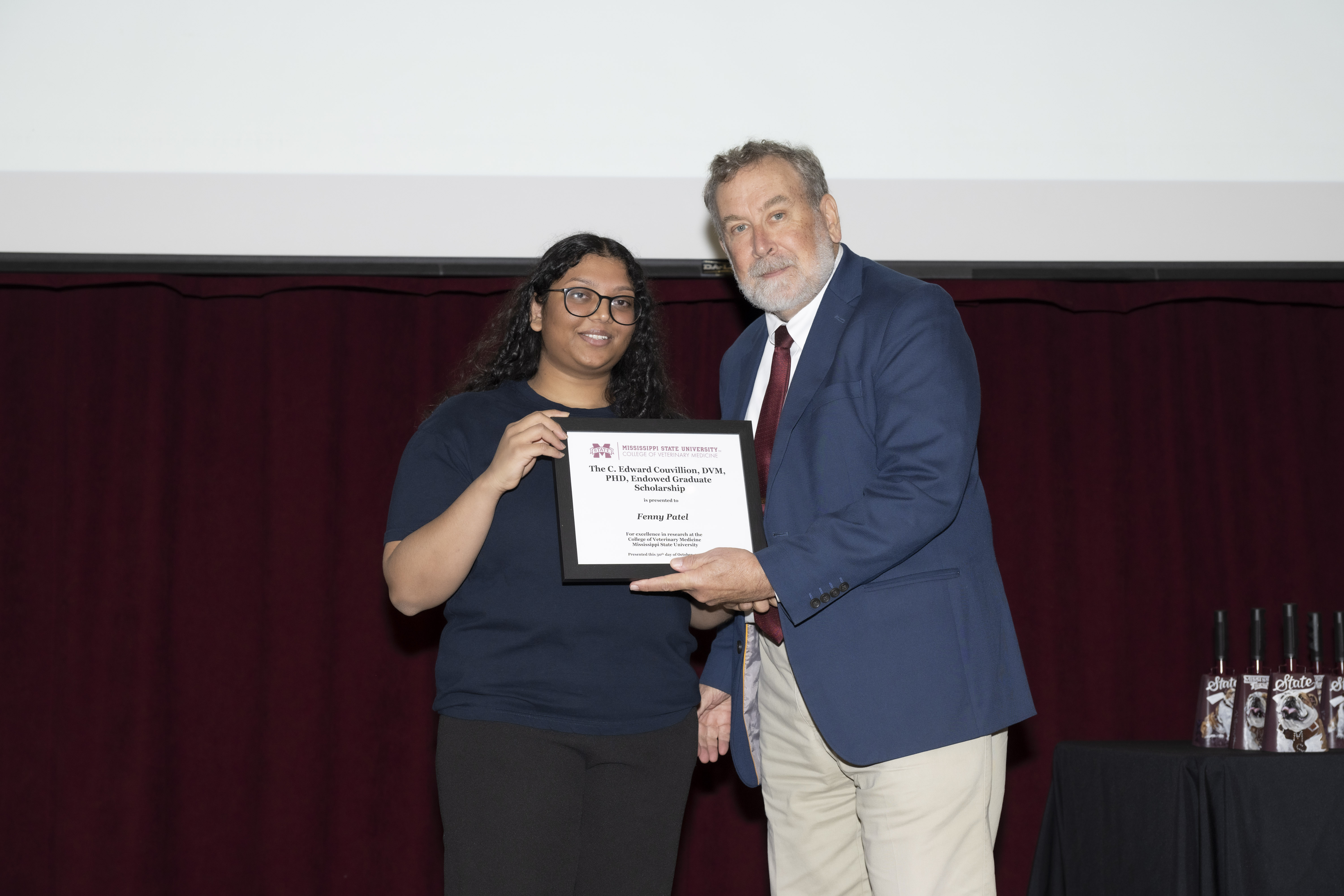 Fenny Patel receives the C. Edward Couvillion, DVM, PhD, Endowed Graduate Scholarship from Dr. David Smith, Associate Dean and Professor.