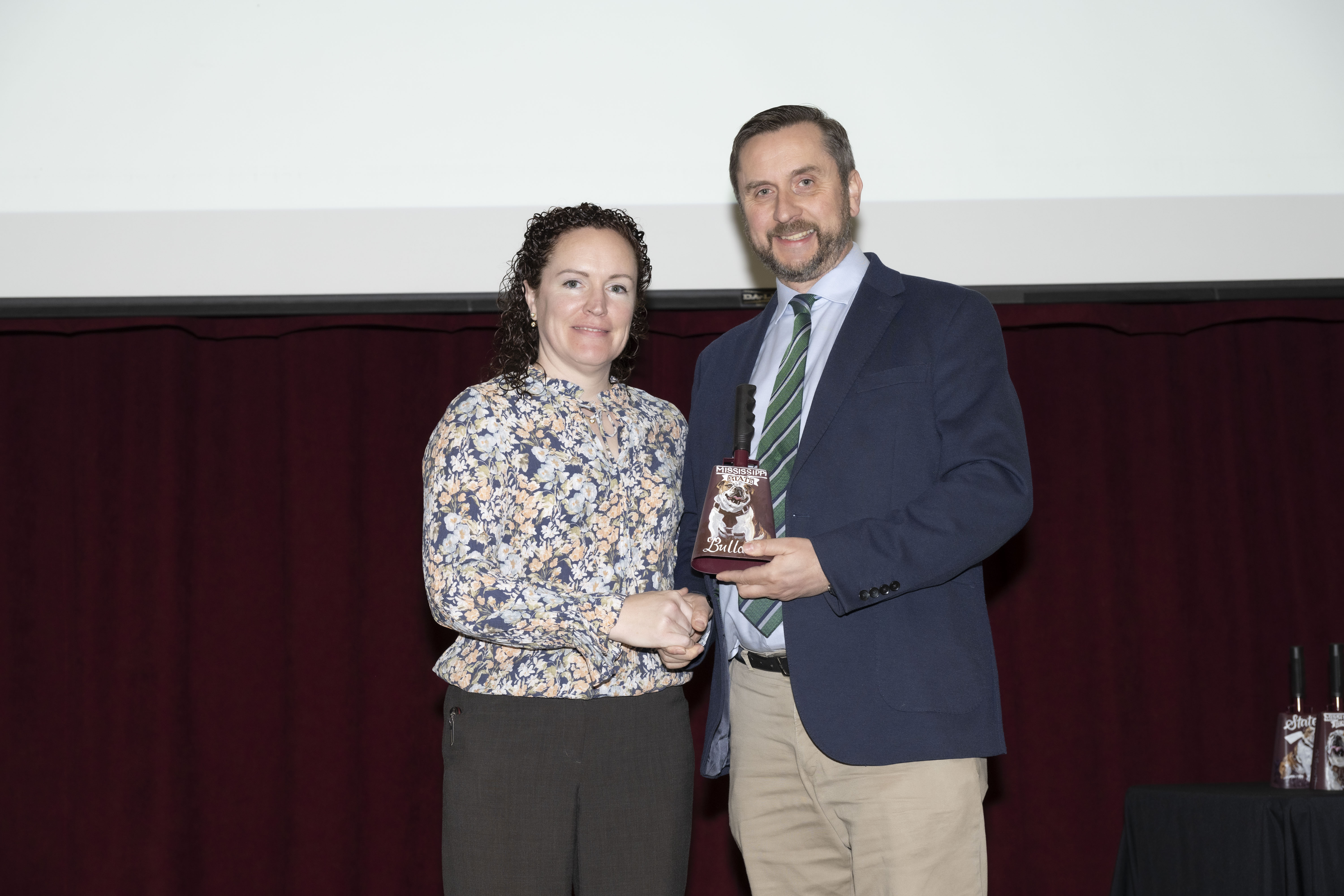 Dr. Caitlin O'Shea receives the Pegasus Award for Teaching from Dr. Philip Robinson, head of the MSU CVM Department of Pathobiology and Population Medicine.