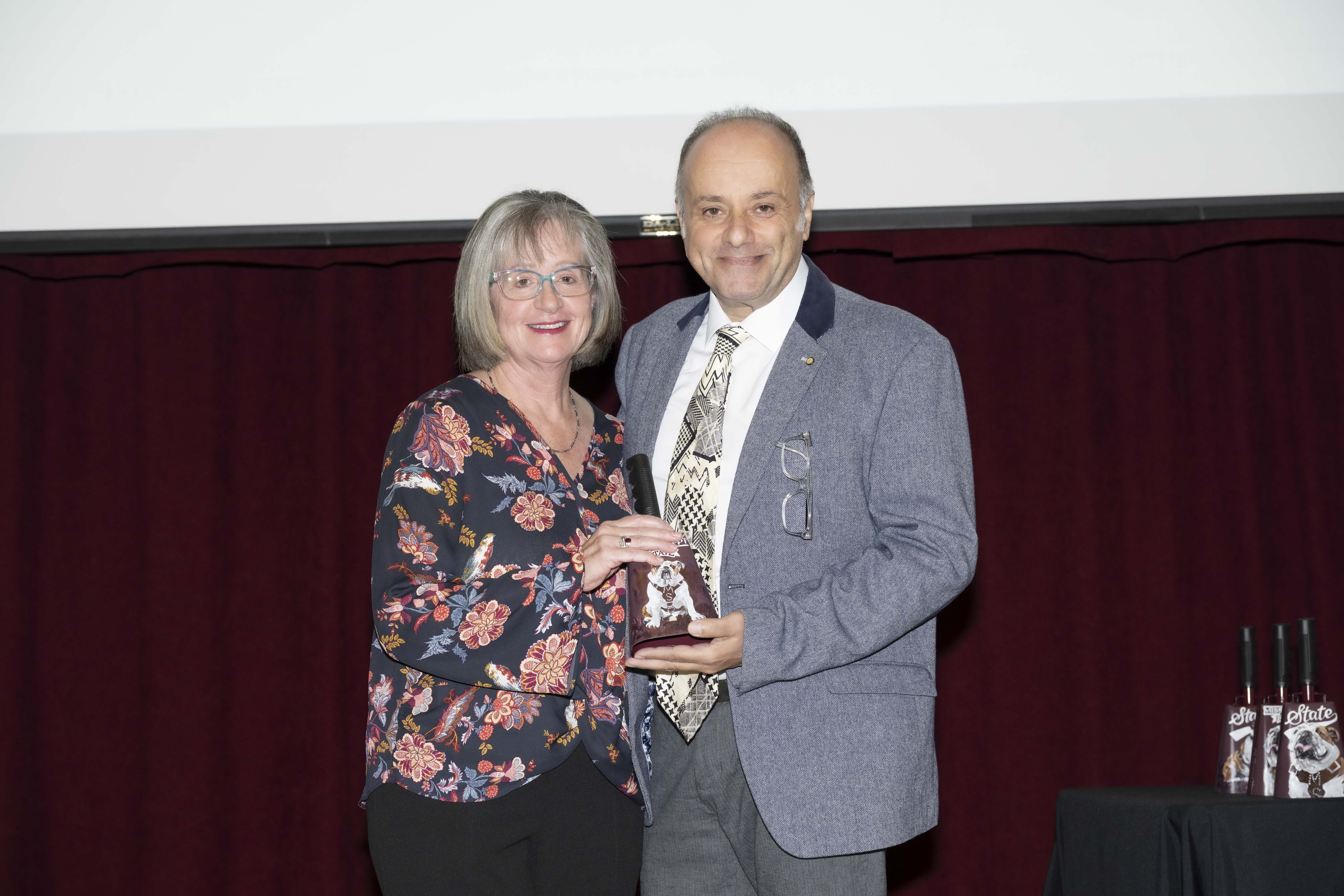 Dr. Lora Petrie-Hanson receives the Pegasus Award for Research from Dr. Michail Panagiotidis, PhD, head of the Department of Comparative Biomedical Sciences.