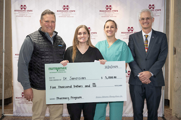 Four people and a big check