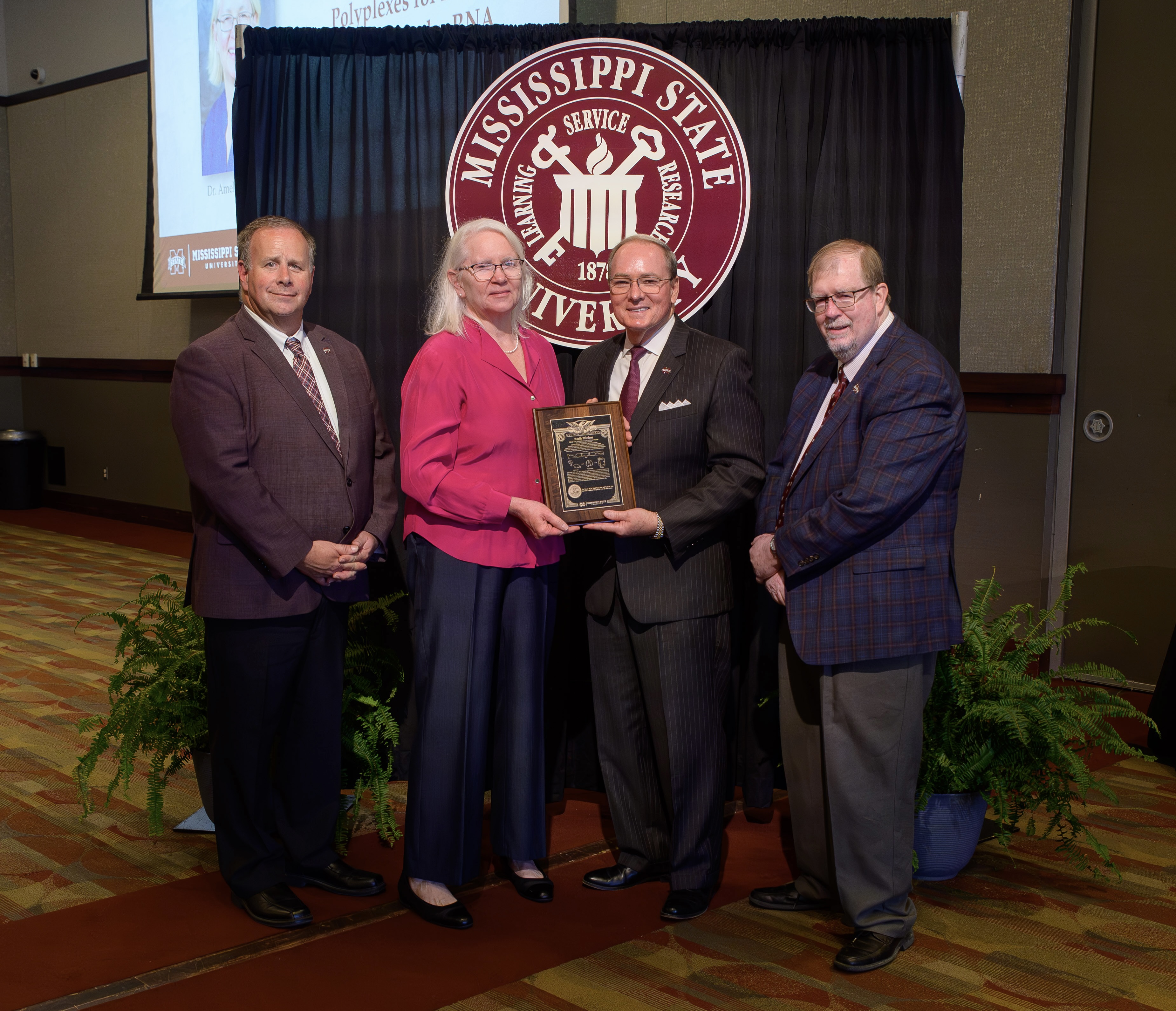 From left to right: Interim Vice President for the Office of Research and Economic Development Scott Willard, Dr. Amelia Woolums, MSU President Mark E. Keenum, Vice President for the Division of Agriculture, Forestry and Veterinary Medicine Keith Coble