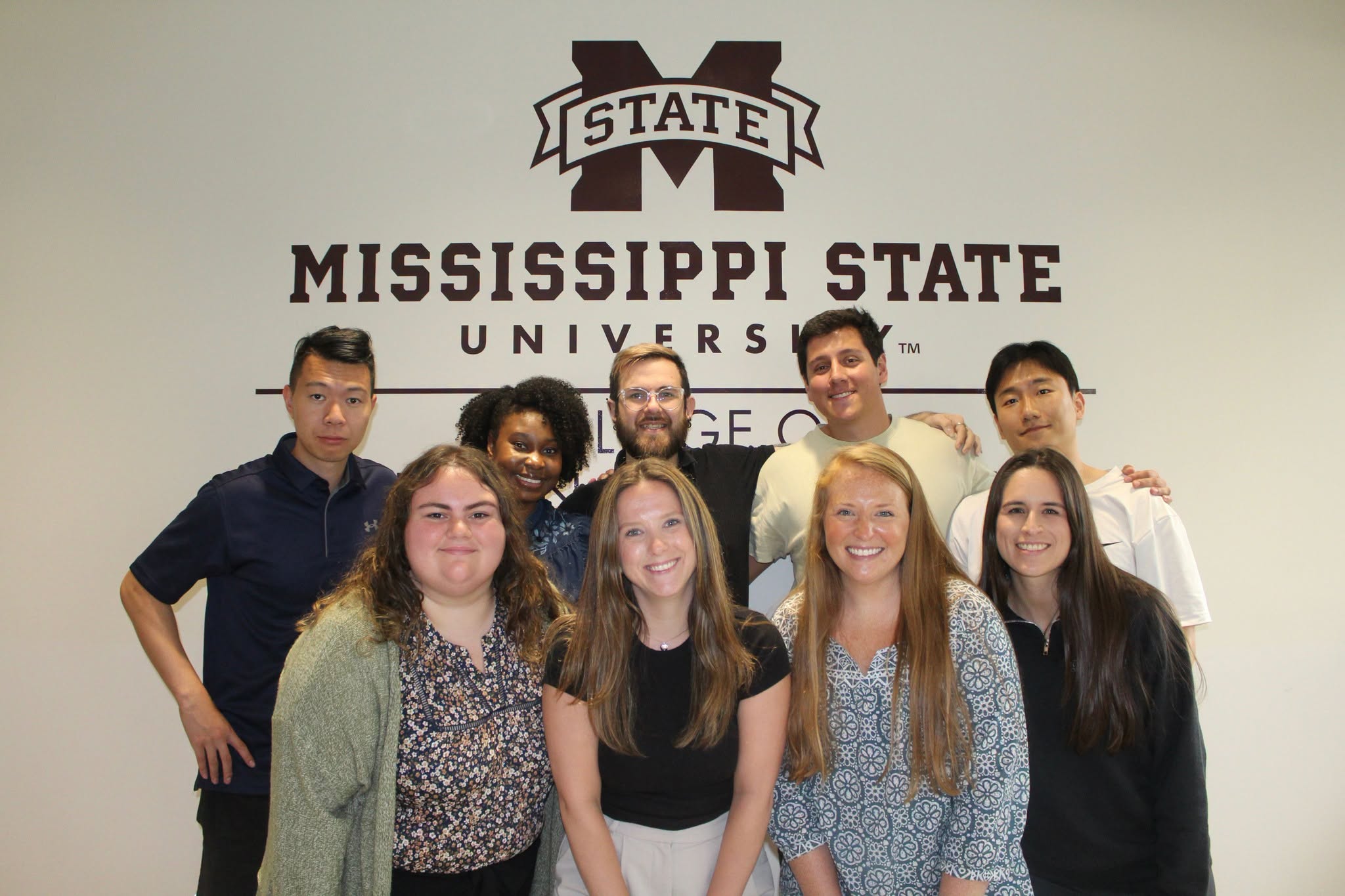 Nine new rotating interns at the Mississippi State University College of Veterinary Medicine smile together during orientation.