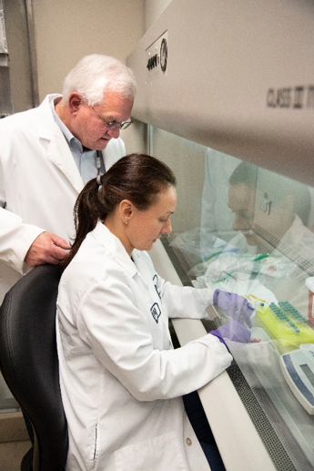 Two researchers study samples