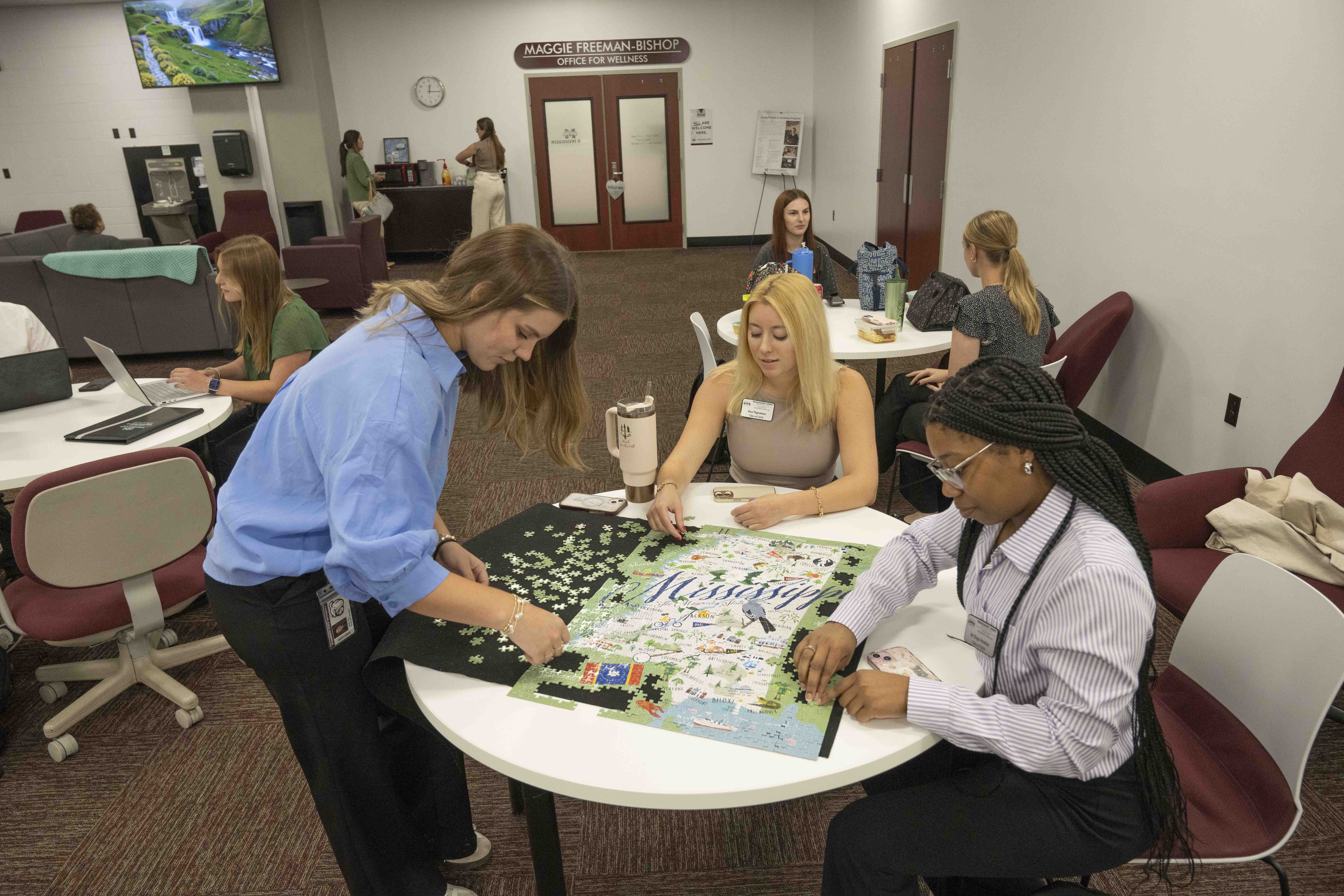 Three students working on a jigsaw puzzle