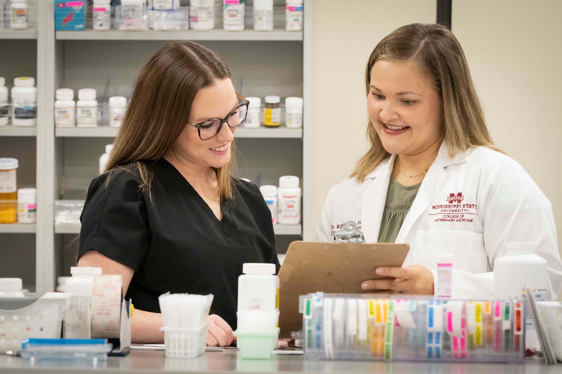 Two veterinary pharmacists in a pharmacy.