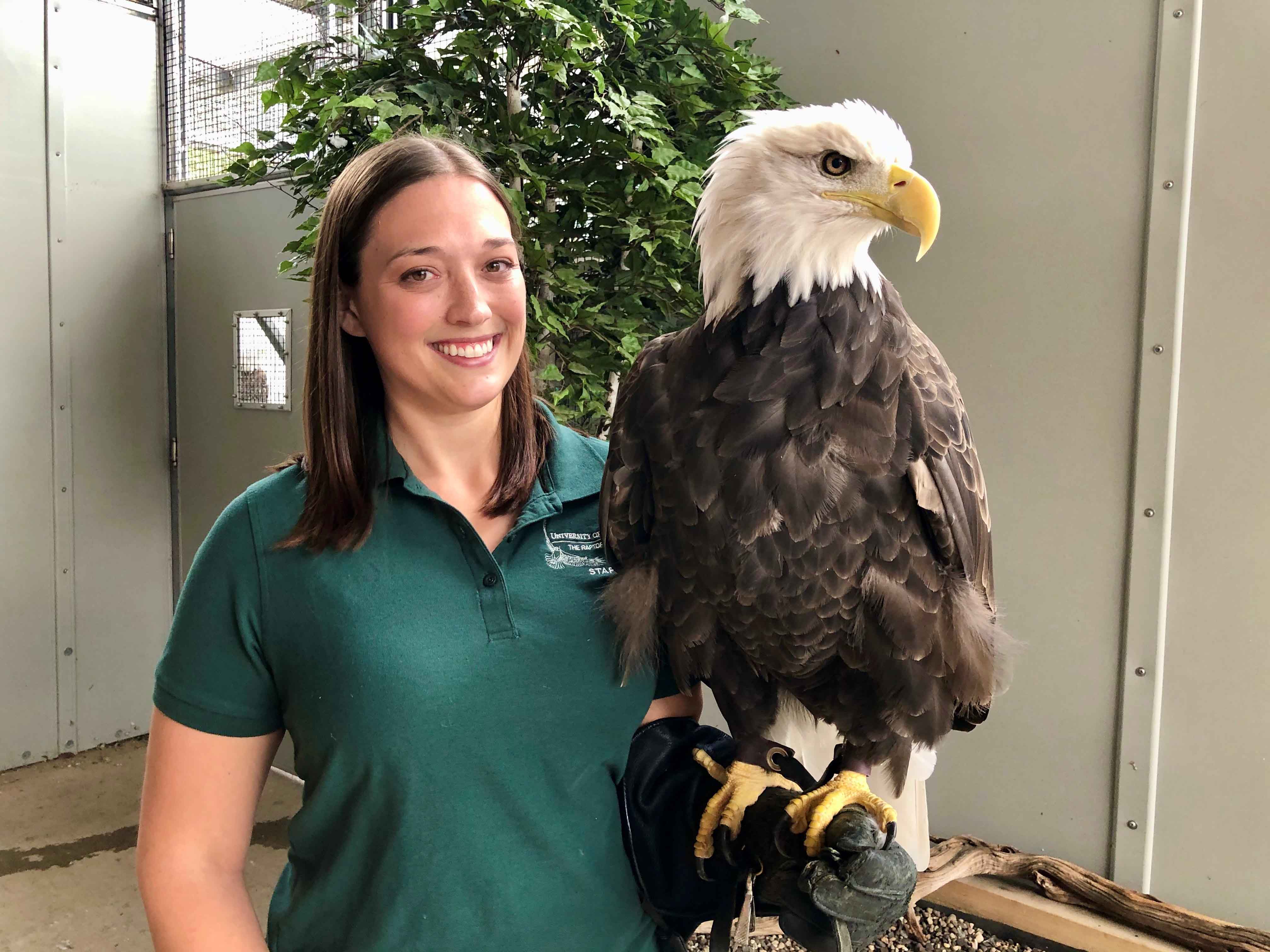 Dr. Tori Hall holds a bald eagle