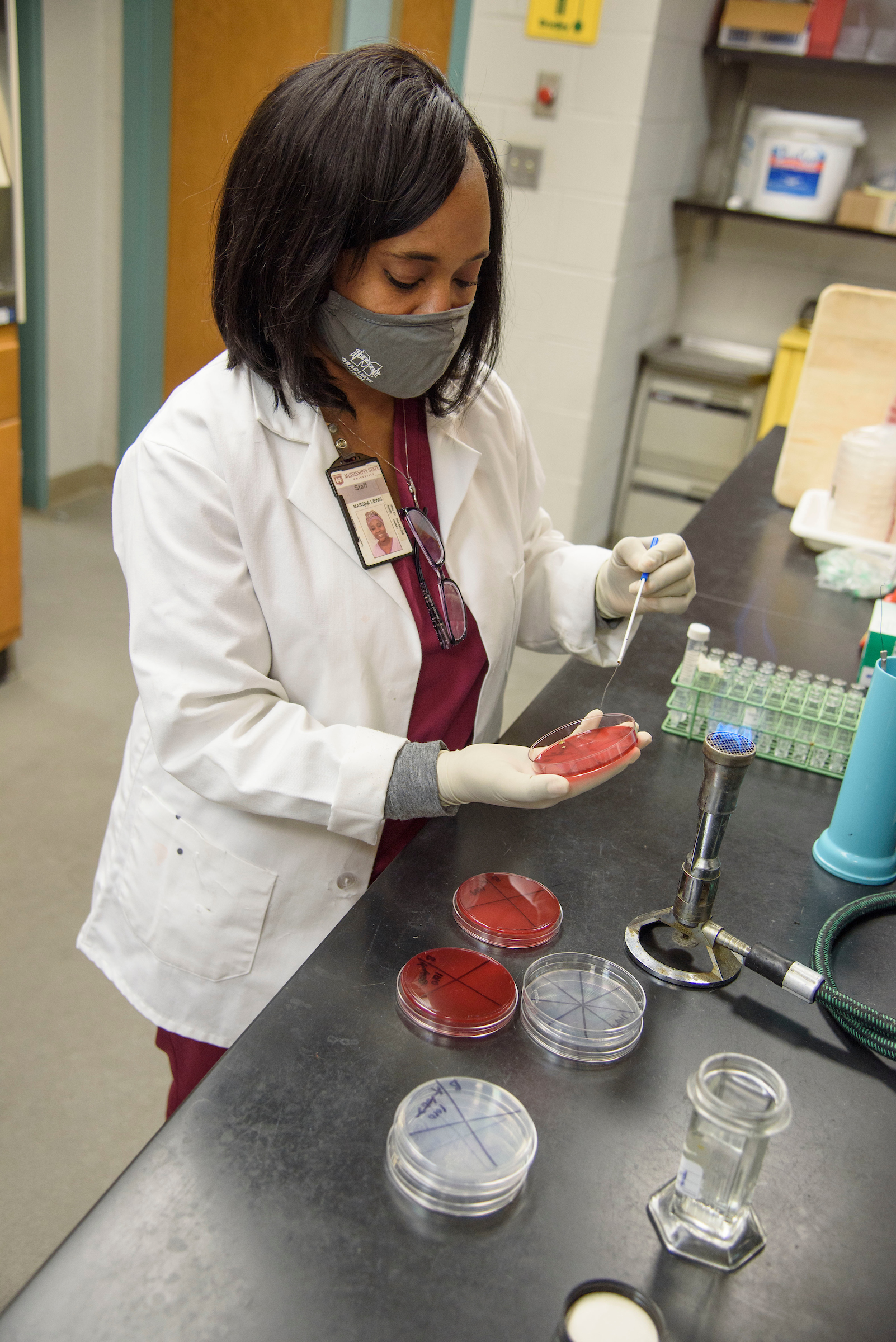 An African American woman prepares a microscope slide to be viewed