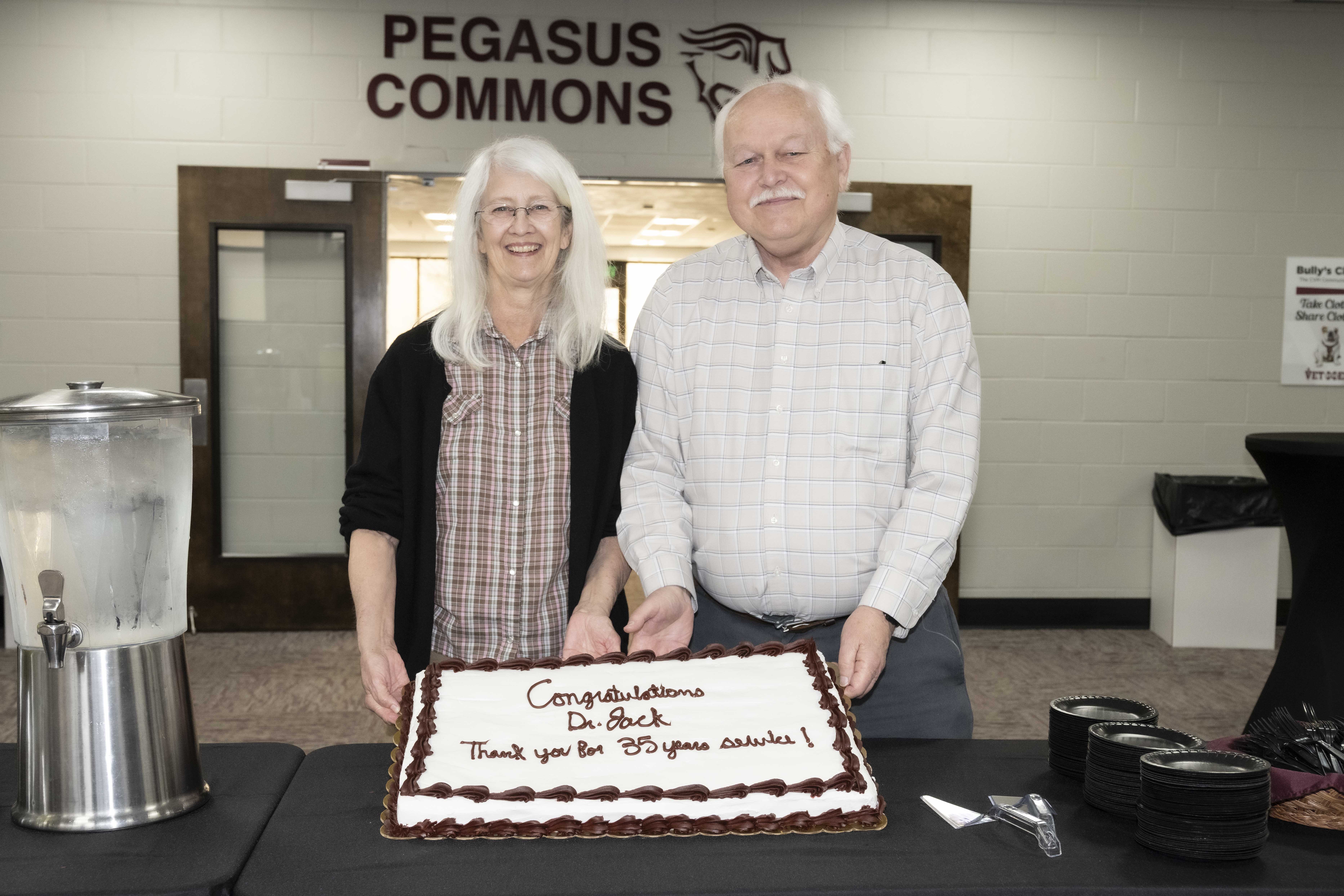 Dr. Skip Jack holding a cake.