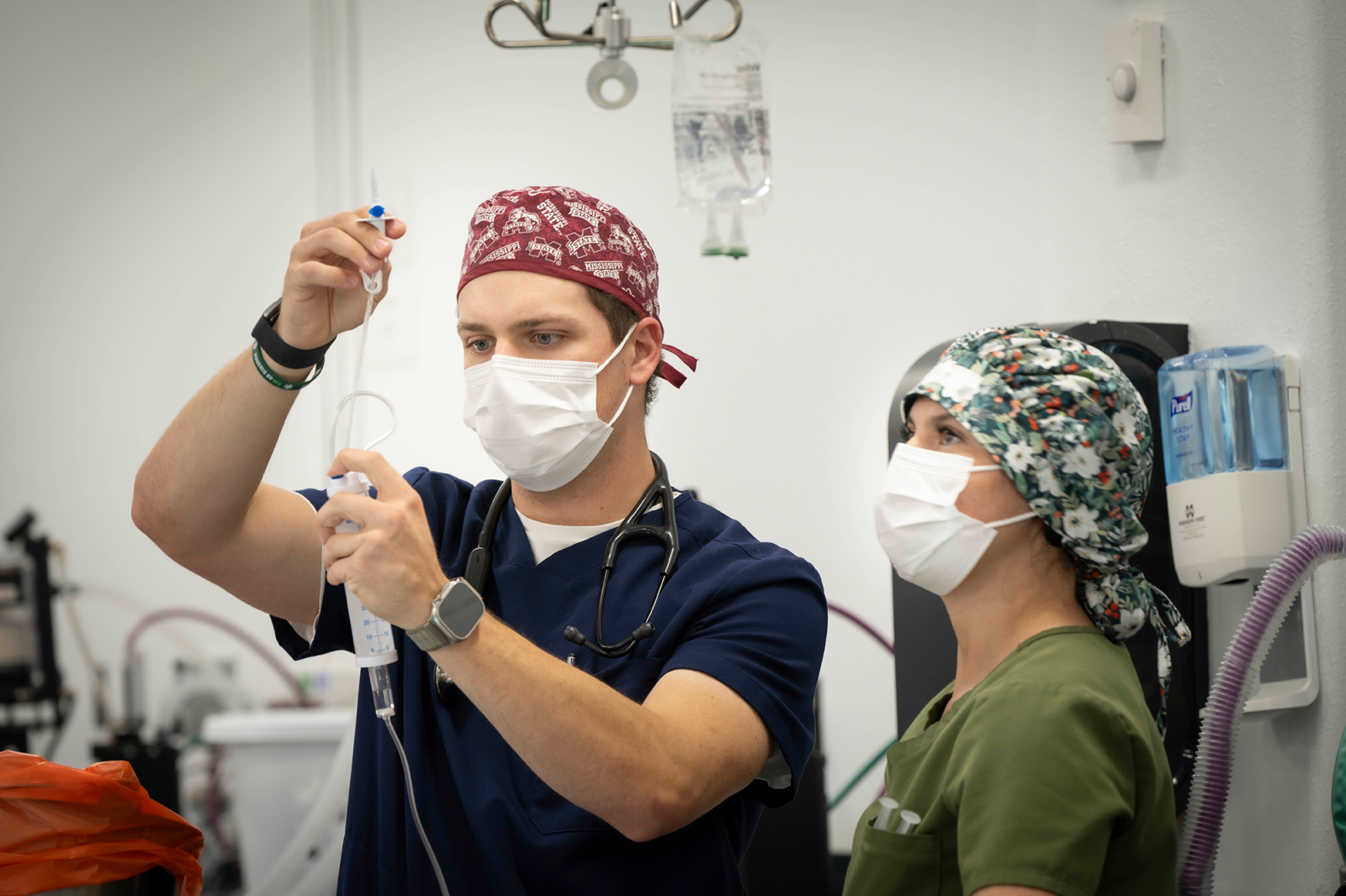 Two vets look at an instrument.